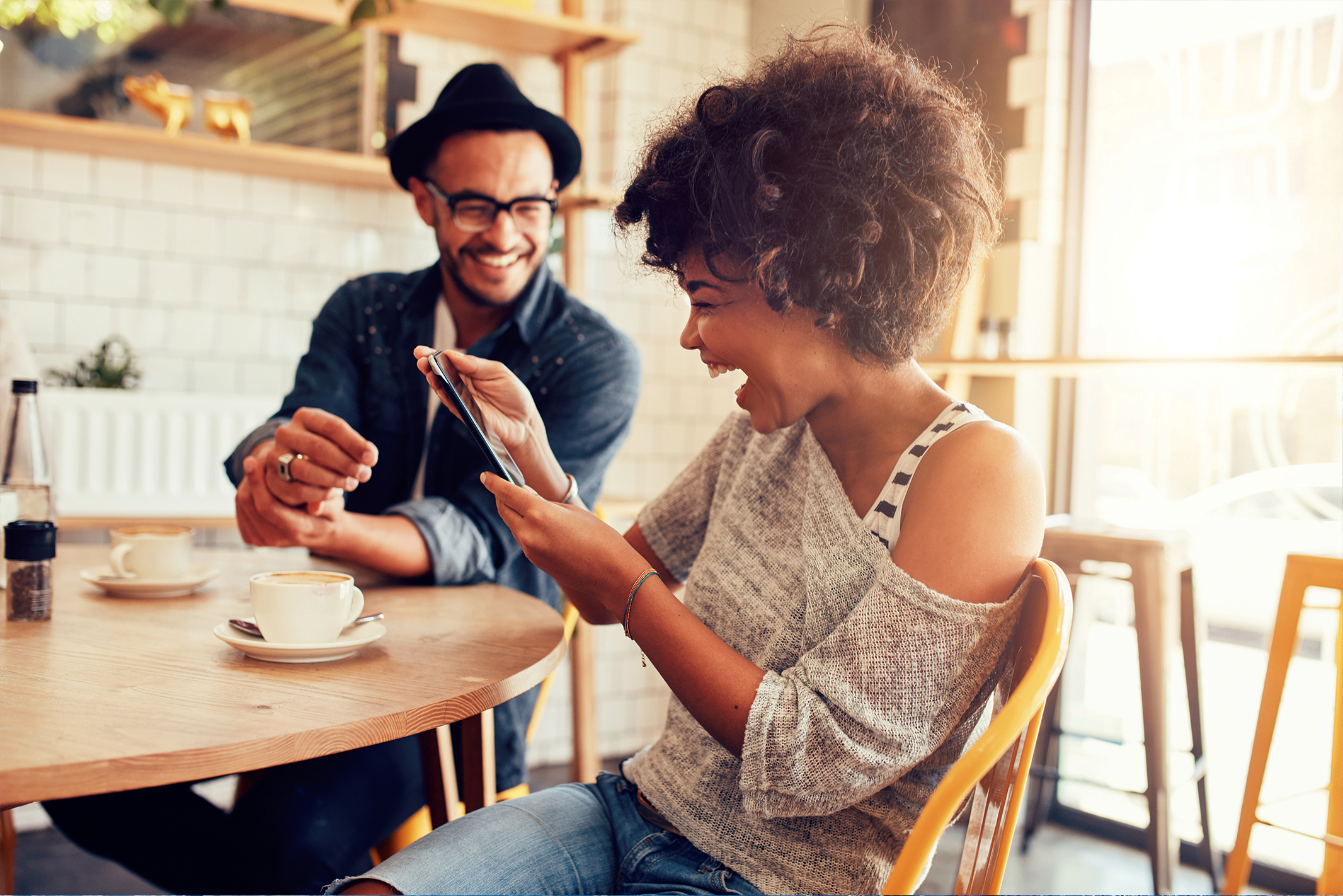 Man and woman with smart phone laughing